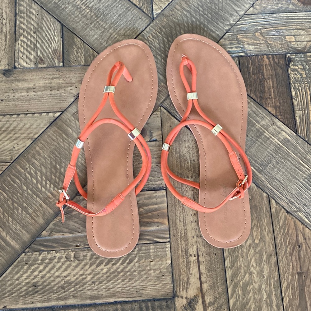 Orange sandals with gold hardware